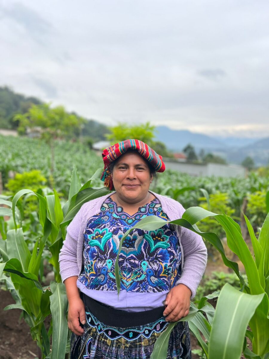 Mujer agricultora guatemalteca mostrando sus cultivos en el Día Internacional de la Mujer Rural